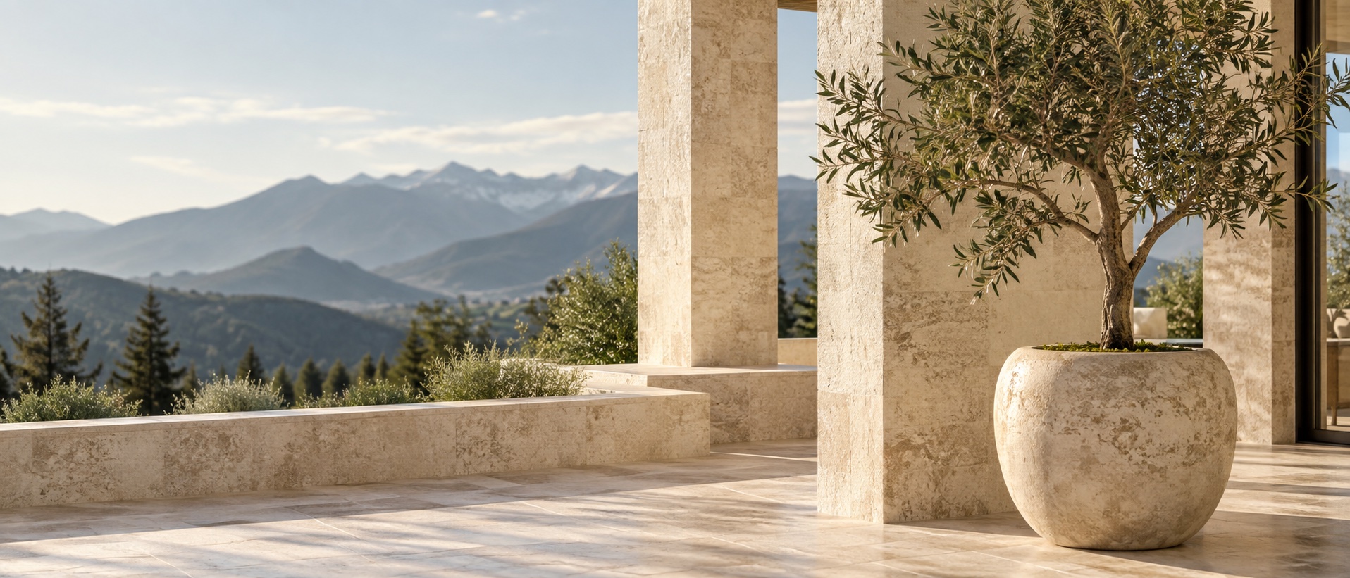 Sunlit travertine terrace with an olive tree and Colorado mountains